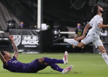 Orlando City's Antonio Carlos, left, celebrates after blocking a shot by LAFC's Diego Rossi, right, during the quarterfinals of the MLS is Back Tournament at Disney's ESPN Wide World of Sports complex in Orlando, Florida, on Friday, July 31, 2020. Orlando City advanced on penalty kicks after a 1-1 draw. (Stephen M. Dowell/Orlando Sentinel/Tribune News Service via Getty Images)