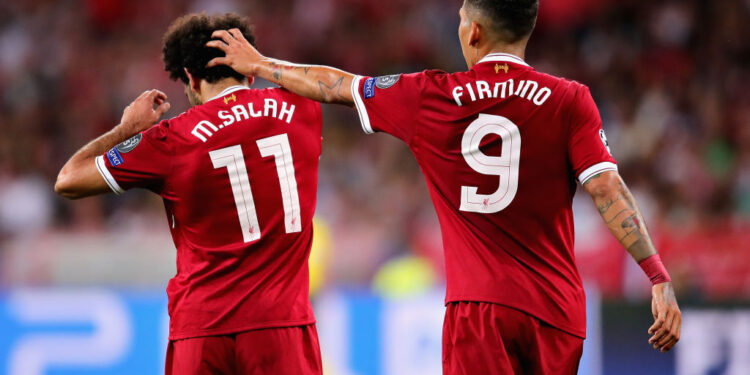 KIEV, UKRAINE - MAY 26: Roberto Firmino of Liverpool comforts teammate Mohamed Salah after his injury during the UEFA Champions League final between Real Madrid and Liverpool at NSC Olimpiyskiy Stadium on May 26, 2018 in Kiev, Ukraine.  (Photo by Chris Brunskill Ltd/Getty Images)