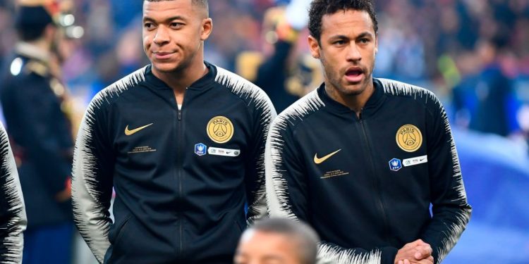 Paris Saint-Germain's French forward Kylian Mbappe (L) and Brazilian forward Neymar react as stand prior to the start of the French Cup final football match between Rennes (SRFC) and Paris Saint-Germain (PSG), on April 27, 2019 at the Stade de France in Saint-Denis, outside Paris. (Photo by Damien MEYER / AFP)        (Photo credit should read DAMIEN MEYER/AFP/Getty Images)