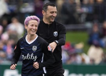 TACOMA, WA - SEPTEMBER 29:  Megan Rapinoe #15 of Reign FC smiles with Reign FC coach Vlatko Andonovski after being subbed out in the second half of the game at Cheney Stadium on September 29, 2019 in Tacoma, Washington. Reign FC won 2-0. (Photo by Lindsey Wasson/Getty Images)