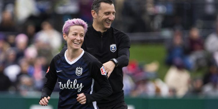 TACOMA, WA - SEPTEMBER 29:  Megan Rapinoe #15 of Reign FC smiles with Reign FC coach Vlatko Andonovski after being subbed out in the second half of the game at Cheney Stadium on September 29, 2019 in Tacoma, Washington. Reign FC won 2-0. (Photo by Lindsey Wasson/Getty Images)