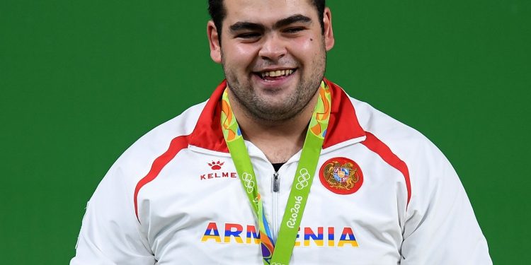 RIO DE JANEIRO, BRAZIL - AUGUST 16:  Silver medalist Gor Minasyan of Armenia stands on the podium during the medal ceremony for the Men's +105kg Weightlifting contest on Day 11 of the Rio 2016 Olympic Games at Riocentro - Pavilion 2 on August 16, 2016 in Rio de Janeiro, Brazil.  (Photo by Matthias Hangst/Getty Images)