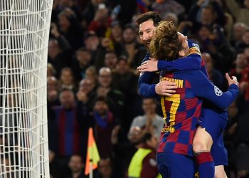 Barcelona's Argentine forward Lionel Messi (up) celebrates with teammate Barcelona's French forward Antoine Griezmann after scoring a goal during the UEFA Champions League Group F football match between FC Barcelona and Borussia Dortmund at the Camp Nou stadium in Barcelona, on November 27, 2019. (Photo by Josep LAGO / AFP) (Photo by JOSEP LAGO/AFP via Getty Images)