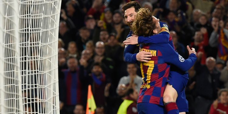 Barcelona's Argentine forward Lionel Messi (up) celebrates with teammate Barcelona's French forward Antoine Griezmann after scoring a goal during the UEFA Champions League Group F football match between FC Barcelona and Borussia Dortmund at the Camp Nou stadium in Barcelona, on November 27, 2019. (Photo by Josep LAGO / AFP) (Photo by JOSEP LAGO/AFP via Getty Images)