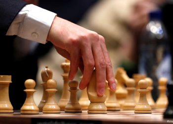FILE PHOTO: Chess - 2018 World Chess Championship - Magnus Carlsen v Fabiano Caruana - London, Britain - November 26, 2018     USA's Fabiano Caruana plays a move during round 12 of the World Chess Championship Final   REUTERS/Paul Childs/File Photo - RC113399E4C0