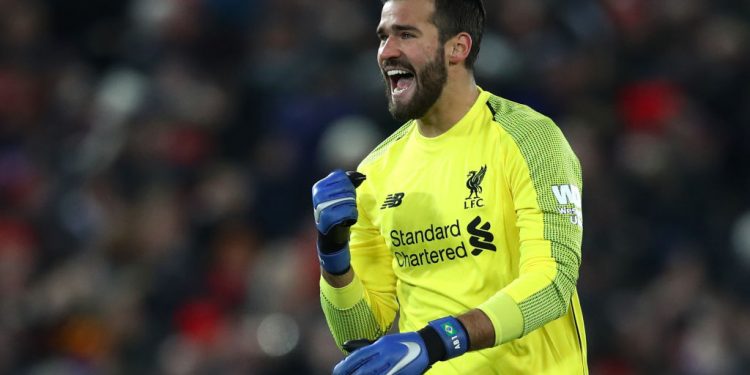 LIVERPOOL, ENGLAND - DECEMBER 16:  Alisson of Liverpool celebrates after his team mate Sadio Mane of Liverpool (not pictured) scored their team's first goal during the Premier League match between Liverpool FC and Manchester United at Anfield on December 16, 2018 in Liverpool, United Kingdom.  (Photo by Clive Brunskill/Getty Images)