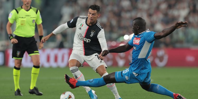 TURIN, ITALY - AUGUST 31:  Cristiano Ronaldo of Juventus is challenged by Kalidou Koulibaly of SSC Napoli during the Serie A match between Juventus and SSC Napoli at Allianz Stadium on August 31, 2019 in Turin, Italy.  (Photo by Emilio Andreoli/Getty Images )