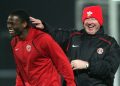 Manchester United's manager Alex Ferguson (right) jokes with Louis Saha during a training session at Lens training ground at La Gayette, Lens.