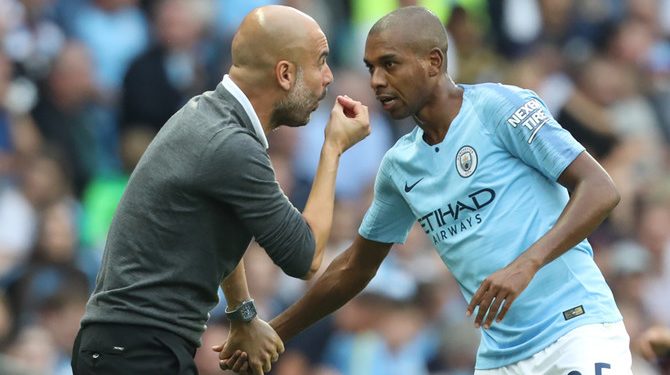Manchester City's Spanish manager Pep Guardiola speaks with Manchester City's Brazilian midfielder Fernandinho during the English Premier League football match between Manchester City and Newcastle United at the Etihad Stadium in Manchester, north west England, on September 1, 2018. (Photo by Lindsey PARNABY / AFP) / RESTRICTED TO EDITORIAL USE. No use with unauthorized audio, video, data, fixture lists, club/league logos or 'live' services. Online in-match use limited to 120 images. An additional 40 images may be used in extra time. No video emulation. Social media in-match use limited to 120 images. An additional 40 images may be used in extra time. No use in betting publications, games or single club/league/player publications. /