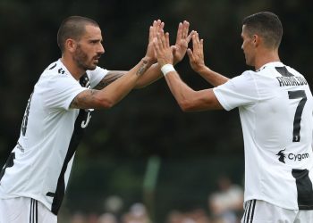 VILLAR PEROSA, ITALY - AUGUST 12:  Cristiano Ronaldo (C) of Juventus celebrates with his team-mate Leonardo Bonucci (L) during the Pre-Season Friendly match between Juventus and Juventus U19 on August 12, 2018 in Villar Perosa, Italy.  (Photo by Marco Luzzani/Getty Images)