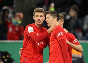 MUNICH, GERMANY - FEBRUARY 05: Robert Lewandowski of FC Bayern Munich celebrates with teammates Thomas Muller and Joshua Kimmich after scoring his team's fourth goal during the DFB Cup round of sixteen match between FC Bayern Muenchen and TSG 1899 Hoffenheim at Allianz Arena on February 05, 2020 in Munich, Germany. (Photo by Alexander Hassenstein/Bongarts/Getty Images)