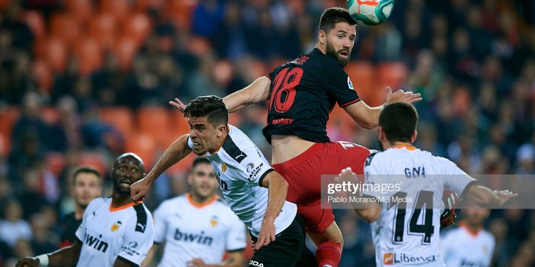 VALENCIA, SPAIN - FEBRUARY 14:   Gabriel Paulista (L) of Valencia competes for the ball with Felipe Augusto (C) of Atletico de Madrid during the Liga match between Valencia CF and Club Atletico de Madrid at Estadio Mestalla on February 14, 2020 in Valencia, Spain. (Photo by Pablo Morano/MB Media/Getty Images)