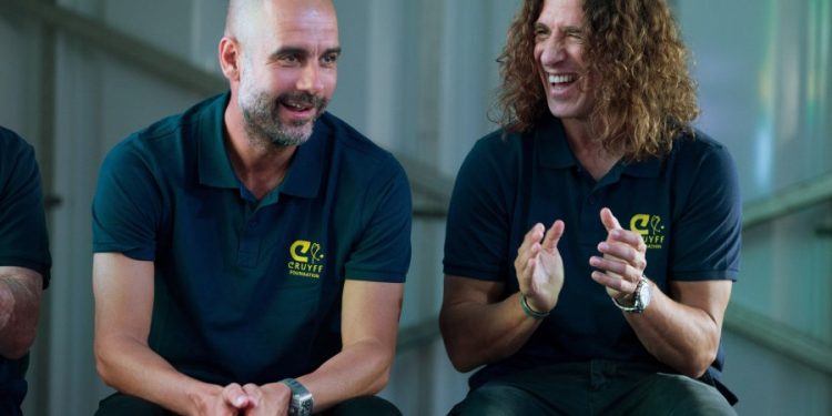 epa06772748 Manchester City's head coach, Pep Guardiola (L), and former FC Barcelona's player Carles Puyol (R) take part in the presentation of the new members of the Cruyff Foundation's Board of Trustees, in Barcelona, Spain, 30 May 2018.  EPA-EFE/Enric Fontcuberta