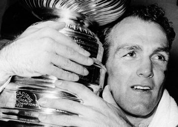 Montreal Canadiens forward Henri Richard hugs the Stanley Cup awarded to the National Hockey League champions in Detroit, Mich., Thursday night, May 5, 1966.  Richard scored the game-winning goal in overtime play to give Montreal the 3-2 win over the Detroit Red Wings in the NHL playoffs.  (AP Photo)