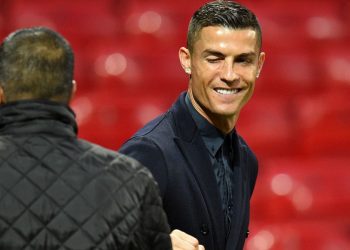 Juventus' Portuguese striker Cristiano Ronaldo winks as he joins teammates during a walkabout inside Old Trafford stadium in Manchester, north west England on October 22, 2018, on the eve of their UEFA Champions League group H football match against Manchester United on October 23. (Photo by Oli SCARFF / AFP)