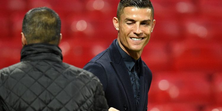 Juventus' Portuguese striker Cristiano Ronaldo winks as he joins teammates during a walkabout inside Old Trafford stadium in Manchester, north west England on October 22, 2018, on the eve of their UEFA Champions League group H football match against Manchester United on October 23. (Photo by Oli SCARFF / AFP)