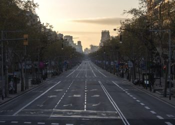 An avenue is seen empty in Barcelona, Spain, Sunday, March 15, 2020. Spain's government announced Saturday that it is placing tight restrictions on movements and closing restaurants and other establishments in the nation of 46 million people as part of a two-week state of emergency to fight the sharp rise in coronavirus infections. For most people, the new coronavirus causes only mild or moderate symptoms. For some, it can cause more severe illness, especially in older adults and people with existing health problems. (AP Photo/Joan Mateu)