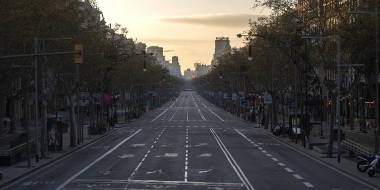 An avenue is seen empty in Barcelona, Spain, Sunday, March 15, 2020. Spain's government announced Saturday that it is placing tight restrictions on movements and closing restaurants and other establishments in the nation of 46 million people as part of a two-week state of emergency to fight the sharp rise in coronavirus infections. For most people, the new coronavirus causes only mild or moderate symptoms. For some, it can cause more severe illness, especially in older adults and people with existing health problems. (AP Photo/Joan Mateu)