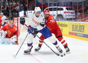 BRATISLAVA, SLOVAKIA - MAY10: Norway’s Andreas Martinsen #27 plays the puck while Russia’s Dinar Khafizullin #3 defends during preliminary round action at the 2019 IIHF Ice Hockey World Championship at Ondrej Nepela Arena on May 10, 2019 in Bratislava, Slovakia. (Photo by Andre Ringuette/HHOF-IIHF Images)