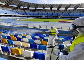 (FILES) In this file photo taken on March 04, 2020 Picture taken on March 4, 2020 shows cleaners wearing a protective suit, as they sanitise the seats of the San Paolo stadium in Naples. - Hiring is surging and wages are rising in the United States as the year begins, but the coronavirus is poised to infect the economy and hamper President Donald Trump's re-election bid.
Wall Street has tumbled in recent days as the outbreak spread and undermined the view that the US economy is inoculated against the danger.
The White House has tried to downplay the impact, and Trump on march 6, 2020 even made the extraordinary claim that US businesses are benefitting from people staying in the country while predicting stocks would bounce back. (Photo by CIRO FUSCO / ANSA / AFP) / - Italy OUT