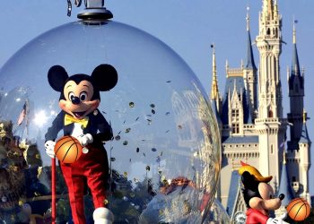 397155 06: Mickey Mouse rides in a parade through Main Street, USA with Cinderella's castle in the background at Disney World's Magic Kingdom November 11, 2001 in Orlando, Florida. (Photo by Joe Raedle/Getty Images)