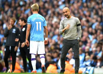 MANCHESTER, ENGLAND - AUGUST 31: Pep Guardiola, Manager of Manchester City speaks with Oleksandr Zinchenko of Manchester City during the Premier League match between Manchester City and Brighton & Hove Albion at Etihad Stadium on August 31, 2019 in Manchester, United Kingdom. (Photo by Shaun Botterill/Getty Images)