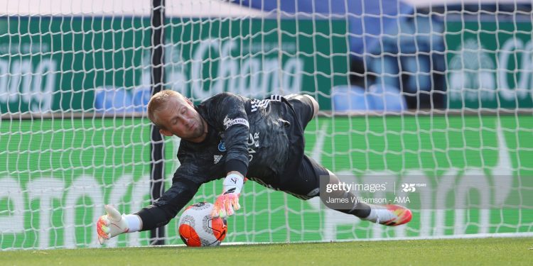 LEICESTER, ENGLAND - JUNE 23:  Kasper Schmeichel of Leicester City saves a penalty taken by Neal Maupay of Brighton and Hove Albion during the Premier League match between Leicester City and Brighton & Hove Albion at The King Power Stadium on June 23, 2020 in Leicester, United Kingdom. Football Stadiums around Europe remain empty due to the Coronavirus Pandemic as Government social distancing laws prohibit fans inside venues resulting in all fixtures being played behind closed doors. (Photo by James Williamson - AMA/Getty Images)