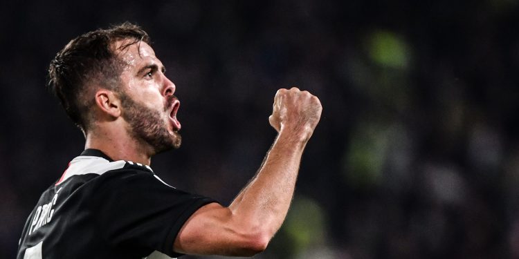 Juventus' Bosnian midfielder Miralem Pjanic celebrates after scoring during the Italian Serie A football match Juventus vs Bologna on October 19, 2019 at the Juventus stadium in Turin. (Photo by Marco Bertorello / AFP) (Photo by MARCO BERTORELLO/AFP via Getty Images)