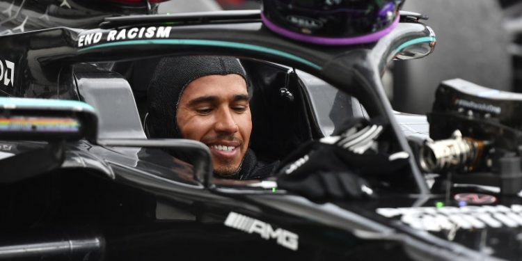 Mercedes driver Lewis Hamilton of Britain smiles in his car after winning the Hungarian Formula One Grand Prix at the Hungaroring racetrack in Mogyorod, Hungary, Sunday, July 19, 2020. (Joe Klamar/Pool via AP)