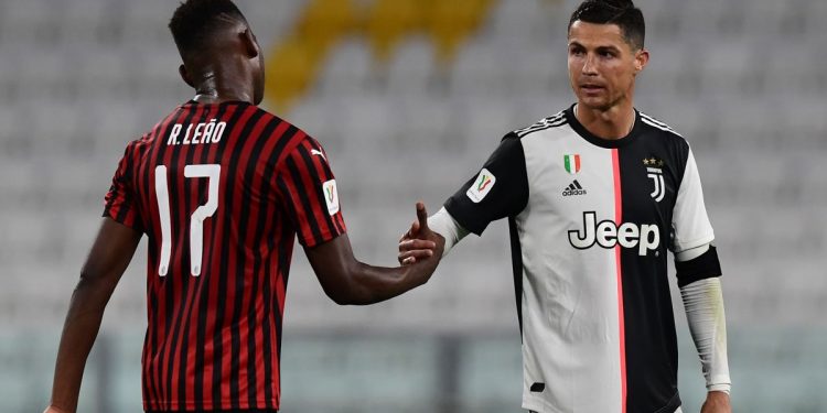 Juventus' Portuguese forward Cristiano Ronaldo taps hand with AC Milan's Portuguese forward Rafael Leao at the end of the Italian Cup (Coppa Italia) semi-final second leg football match Juventus vs AC Milan on June 12, 2020 at the Allianz stadium in Turin, the first to be played in Italy since March 9 and the lockdown aimed at curbing the spread of the COVID-19 infection, caused by the novel coronavirus. (Photo by Miguel MEDINA / AFP) (Photo by MIGUEL MEDINA/AFP via Getty Images)