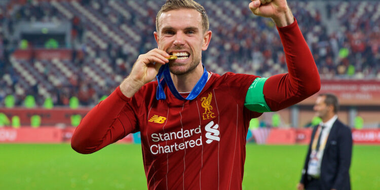 DOHA, QATAR - Saturday, December 21, 2019: Liverpool's captain Jordan Henderson bites his winners' medal after the FIFA Club World Cup Qatar 2019 Final match between CR Flamengo and Liverpool FC at the Khalifa Stadium. Liverpool won 1-0 after extra time. (Pic by David Rawcliffe/Propaganda)