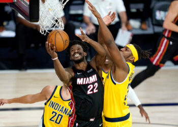 Aug 20, 2020; Lake Buena Vista, Florida, USA; Miami Heat's Jimmy Butler (22) shoots as Indiana Pacers' Myles Turner defends during the second half in an NBA basketball first round playoff game of the 2020 NBA playoffs at The Field House. Mandatory Credit: Ashley Landis/Pool Photo-USA TODAY Sports