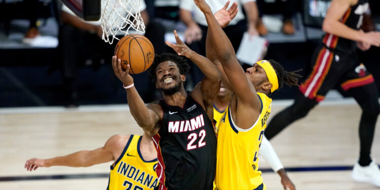Aug 20, 2020; Lake Buena Vista, Florida, USA; Miami Heat's Jimmy Butler (22) shoots as Indiana Pacers' Myles Turner defends during the second half in an NBA basketball first round playoff game of the 2020 NBA playoffs at The Field House. Mandatory Credit: Ashley Landis/Pool Photo-USA TODAY Sports