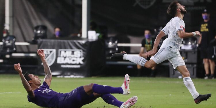 Orlando City's Antonio Carlos, left, celebrates after blocking a shot by LAFC's Diego Rossi, right, during the quarterfinals of the MLS is Back Tournament at Disney's ESPN Wide World of Sports complex in Orlando, Florida, on Friday, July 31, 2020. Orlando City advanced on penalty kicks after a 1-1 draw. (Stephen M. Dowell/Orlando Sentinel/Tribune News Service via Getty Images)