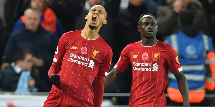 Liverpool's Brazilian midfielder Fabinho (L) celebrates after scoring the opening goal of the English Premier League football match between Liverpool and Manchester City at Anfield in Liverpool, north west England on November 10, 2019. (Photo by Paul ELLIS / AFP) / RESTRICTED TO EDITORIAL USE. No use with unauthorized audio, video, data, fixture lists, club/league logos or 'live' services. Online in-match use limited to 120 images. An additional 40 images may be used in extra time. No video emulation. Social media in-match use limited to 120 images. An additional 40 images may be used in extra time. No use in betting publications, games or single club/league/player publications. /  (Photo by PAUL ELLIS/AFP via Getty Images)