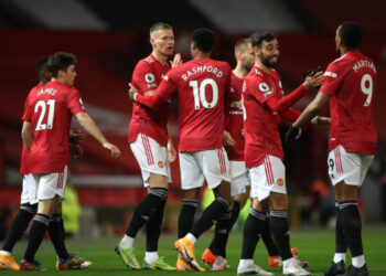 MANCHESTER, ENGLAND - DECEMBER 20: Scott McTominay of Manchester United celebrates with team mates (l - r) Marcus Rashford, Bruno Fernandes and Anthony Martial after scoring their sides first goal during the Premier League match between Manchester United and Leeds United at Old Trafford on December 20, 2020 in Manchester, England. The match will be played without fans, behind closed doors as a Covid-19 precaution. (Photo by Nick Potts - Pool/Getty Images)