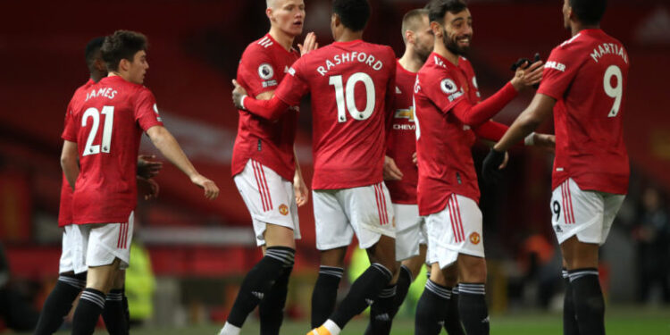 MANCHESTER, ENGLAND - DECEMBER 20: Scott McTominay of Manchester United celebrates with team mates (l - r) Marcus Rashford, Bruno Fernandes and Anthony Martial after scoring their sides first goal during the Premier League match between Manchester United and Leeds United at Old Trafford on December 20, 2020 in Manchester, England. The match will be played without fans, behind closed doors as a Covid-19 precaution. (Photo by Nick Potts - Pool/Getty Images)