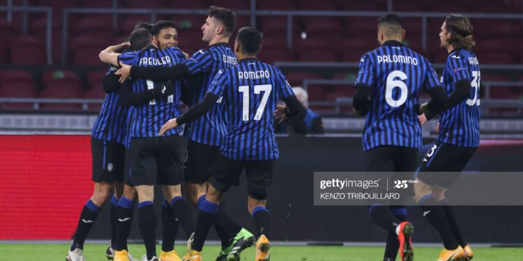 Atalanta's Colombian forward Luis Muriel (2nd-L) is congratulated by teammates after scoring a goal during the UEFA Champions League Group D football match between Ajax Amsterdam and Atalanta Bergamo, at the Johan Cruijff stadium in Amsterdam, on December 9, 2020. (Photo by Kenzo Tribouillard / AFP) (Photo by KENZO TRIBOUILLARD/AFP via Getty Images)