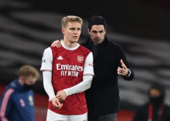 Arsenal's Norwegian midfielder Martin Odegaard (L) gets instructions from Arsenal's Spanish manager Mikel Arteta (R) as he comes on as a substitute during the English Premier League football match between Arsenal and Manchester United at the Emirates Stadium in London on January 30, 2021. (Photo by Shaun Botterill / POOL / AFP) / RESTRICTED TO EDITORIAL USE. No use with unauthorized audio, video, data, fixture lists, club/league logos or 'live' services. Online in-match use limited to 120 images. An additional 40 images may be used in extra time. No video emulation. Social media in-match use limited to 120 images. An additional 40 images may be used in extra time. No use in betting publications, games or single club/league/player publications. /  (Photo by SHAUN BOTTERILL/POOL/AFP via Getty Images)