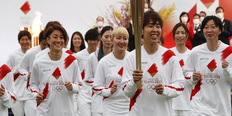 Tokyo 2020 Olympic Torch Relay Grand Start torchbearer Nadeshiko Japan, Japan's women's national soccer team, leads the torch relay in Naraha, Fukushima prefecture, Japan March 25, 2021. REUTERS/Kim Kyung-Hoon/Pool