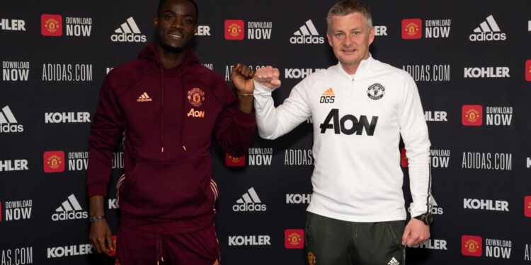 Eric Bailly of Manchester United poses with Ole Gunnar Solskjaer after signing a contract extension at Aon Training Complex on 26 April 2021. Photographer: Ash Donelon