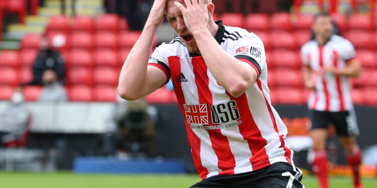 Sheffield United's English midfielder John Lundstram reacts after seeing his shot saved during the English Premier League football match between Sheffield United and Leeds United at Bramall Lane in Sheffield, northern England on September 27, 2020. (Photo by Alex Livesey / POOL / AFP) / RESTRICTED TO EDITORIAL USE. No use with unauthorized audio, video, data, fixture lists, club/league logos or 'live' services. Online in-match use limited to 120 images. An additional 40 images may be used in extra time. No video emulation. Social media in-match use limited to 120 images. An additional 40 images may be used in extra time. No use in betting publications, games or single club/league/player publications. /  (Photo by ALEX LIVESEY/POOL/AFP via Getty Images)
