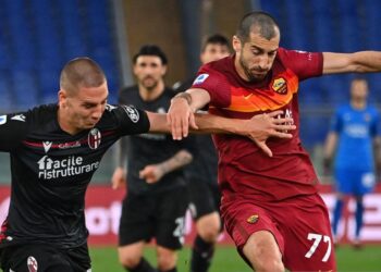 Bologna's Bulgarian defender Valentin Antov (L) and Roma's Armenian midfielder Henrikh Mkhitaryan go for the ball during the Italian Serie A football match AS Rome vs Bologna on April 11, 2021 at the Olympic stadium in Rome. (Photo by ANDREAS SOLARO / AFP) (Photo by ANDREAS SOLARO/AFP via Getty Images)