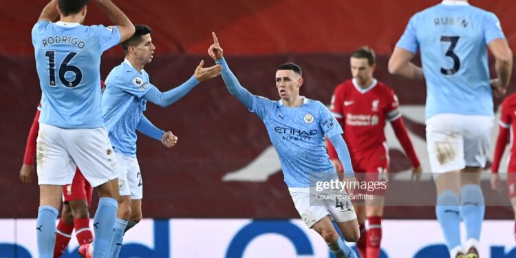 LIVERPOOL, ENGLAND - FEBRUARY 07: Phil Foden of Manchester City celebrates after scoring their side's fourth goal during the Premier League match between Liverpool and Manchester City at Anfield on February 07, 2021 in Liverpool, England. Sporting stadiums around the UK remain under strict restrictions due to the Coronavirus Pandemic as Government social distancing laws prohibit fans inside venues resulting in games being played behind closed doors. (Photo by Laurence Griffiths/Getty Images)