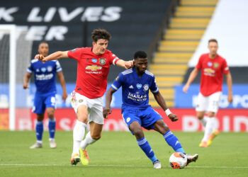 LEICESTER, ENGLAND - JULY 26: Kelechi Iheanacho of Leicester City is challenged by Harry Maguire of Manchester United during the Premier League match between Leicester City and Manchester United at The King Power Stadium on July 26, 2020 in Leicester, England.Football Stadiums around Europe remain empty due to the Coronavirus Pandemic as Government social distancing laws prohibit fans inside venues resulting in all fixtures being played behind closed doors. (Photo by Michael Regan/Getty Images)