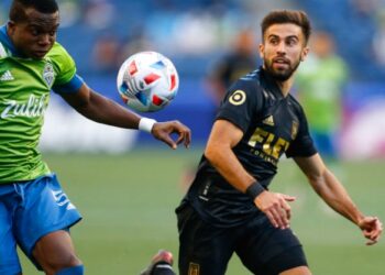 May 16, 2021; Seattle, Washington, USA; Seattle Sounders FC defender Nouhou (5) heads the ball in front of Los Angeles FC forward Diego Rossi (9) during the second half at Lumen Field. Mandatory Credit: Jennifer Buchanan-USA TODAY Sports