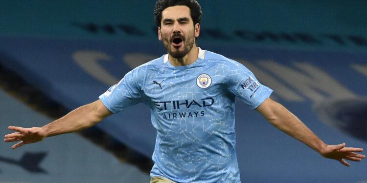 Manchester City's German midfielder Ilkay Gundogan celebrates scoring his team's third goal during the English Premier League football match between Manchester City and Tottenham Hotspur at the Etihad Stadium in Manchester, north west England, on February 13, 2021. (Photo by Rui Vieira / POOL / AFP) / RESTRICTED TO EDITORIAL USE. No use with unauthorized audio, video, data, fixture lists, club/league logos or 'live' services. Online in-match use limited to 120 images. An additional 40 images may be used in extra time. No video emulation. Social media in-match use limited to 120 images. An additional 40 images may be used in extra time. No use in betting publications, games or single club/league/player publications. /  (Photo by RUI VIEIRA/POOL/AFP via Getty Images)