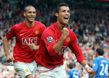 Manchester United's Portuguese forward Cristiano Ronaldo (R) celebrates in front of team-mate Rio Ferdinand after scoring the second goal against WIgan Athletic during the Premier league football match at Old Trafford, Manchester, north-west England, 06 October 2007.  AFP PHOTO / ANDREW YATES   Mobile and website use of domestic English football pictures are subject to obtaining a Photographic End User Licence from Football DataCo Ltd Tel : +44 (0) 207 864 9121 or e-mail accreditations@football-dataco.com - applies to Premier and Football League matches. (Photo credit should read ANDREW YATES/AFP via Getty Images) Manchester United have confirmed they have reached an agreement to re-sign Cristiano Ronaldo from Juventus.