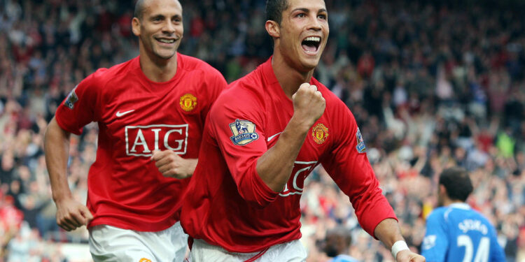 Manchester United's Portuguese forward Cristiano Ronaldo (R) celebrates in front of team-mate Rio Ferdinand after scoring the second goal against WIgan Athletic during the Premier league football match at Old Trafford, Manchester, north-west England, 06 October 2007.  AFP PHOTO / ANDREW YATES   Mobile and website use of domestic English football pictures are subject to obtaining a Photographic End User Licence from Football DataCo Ltd Tel : +44 (0) 207 864 9121 or e-mail accreditations@football-dataco.com - applies to Premier and Football League matches. (Photo credit should read ANDREW YATES/AFP via Getty Images) Manchester United have confirmed they have reached an agreement to re-sign Cristiano Ronaldo from Juventus.