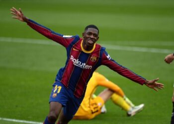 Barcelona's French forward Ousmane Dembele celebrates after scoring a goal during the Spanish league football match between Sevilla FC and FC Barcelona at the Ramon Sanchez Pizjuan stadium in Seville on February 27, 2021. (Photo by CRISTINA QUICLER / AFP) (Photo by CRISTINA QUICLER/AFP via Getty Images)